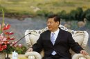China's Vice President Xi listens to U.S. Secretary of Defense Panetta in Beijing