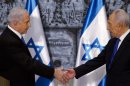 Israeli PM Netanyahu and Israeli President Peres shake hands at the conclusion of a brief ceremony at the president's residence in Jerusalem