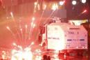 Fireworks thrown by protesters explode near a police water cannon dispersing a rally against Turkey's PM Erdogan in Ankara