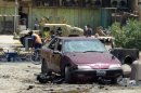 The scene of a car bomb in the Shiite bastion of Sadr City, eastern Baghdad in July 2012