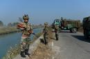 After winning back control of a canal that supplies much of Delhi's water, security forces stand guard