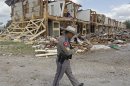 Texas Department of Public Safety Sgt. Jason Reyes walks past a damaged apartment complex, Sunday, April 21, 2013, four days after an explosion at a fertilizer plant in West, Texas. The massive explosion at the West Fertilizer Co. Wednesday night killed 14 people and injured more than 160. (AP Photo/The Dallas Morning News, Michael Ainsworth, Pool)