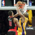 Los Angeles Lakers guard Kobe Bryant (24) slam-dunks for two points as Toronto Raptors guard DeMar DeRozan (10) tries to block in overtime of an NBA basketball game in Los Angeles Friday, March 8, 2013. The basket put the Lakers ahead to stay as they won 118-116. (AP Photo/Reed Saxon)