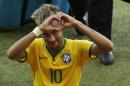 Brazil's Neymar forms a heart with his hands as he leaves the pitch after the World Cup round of 16 soccer match between Brazil and Chile at the Mineirao Stadium in Belo Horizonte, Brazil, Saturday, June 28, 2014. Brazil won 3-2 on penalties after the match ended 1-1 draw after extra-time. (AP Photo/Hassan Ammar)