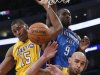 Oklahoma City Thunder's Ibaka fights for a rebound with Los Angeles Lakers World Peace and Sacre of Canada during their NBA basketball game in Los Angeles