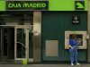 A cleaner cleans the facade of a Bankia-Caja Madrid bank branch in the Andalusian capital of Seville