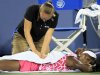 Venus Williams has her back worked on by a trainer during a semifinals match against Li Na, from China, at the Western & Southern Open tennis tournament, Saturday, Aug. 18, 2012, in Mason, Ohio. (AP Photo/Al Behrman)