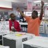 Bernard Gaines, right, describes how wide his window is as he shops for an air conditioner with the help of salesman Leon Blackwood at P.C. Richard & Son, an electronics and appliance store, Tuesday, June 19, 2012 in the Brooklyn borough of New York. Temperatures are expected to approach or top 100 degrees Wednesday and Thursday in cities including New York, Philadelphia and Boston. (AP Photo/Mark Lennihan)
