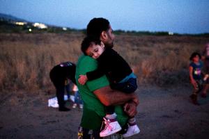 A migrant carries his child on a beach on the Greek&nbsp;&hellip;