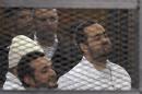 Political activists Ahmed Maher, Ahmed Douma and Mohamed Adel of 6 April movement look on from behind bars in Abdeen court in Cairo