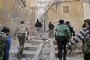 Members of the Free Syrian Army climb up stairs during clashes with pro-government forces in Haram town, Idlib Governorate
