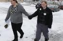 Jessica Chavez, left, and her partner, Alecia Conder, walk through the snow as they leave the Ogden clerk and auditor's office after it had canceled its special Saturday opening to issue marriage licenses in Ogden, Utah, Saturday, Dec. 21, 2013. A federal judge on Friday, struck down Utah's ban on same-sex marriage saying the law violates the U.S. Constitution. (AP photo/George Frey)