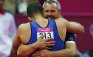 Yin Alvarez, stepfather and coach of Danell Leyva of the U.S., embraces him after he competed in the horizontal bar during the men's individual all-around gymnastics final in the North Greenwich Arena during the London 2012 Olympic Games