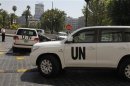 U.N. vehicles carrying a team of United Nations chemical weapons experts leave the hotel where they are staying at in Damascus