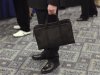 A man holds his briefcase at a job fair in New York