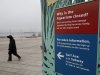 A woman walks past an entrance to the Wildlife Conservation Society's New York Aquarium in Coney Island, New York, Monday, March 25, 2013.  (AP Photo/Seth Wenig)