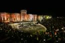 People attend a music concert in the ancient theatre of Syria's ravaged Palmyra on May 6, 2016 following its recapture by regime forces from the Islamic State group fighter