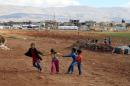Syrian refugee children play on November 15, 2015, at a makeshift camp by Taybeh village, in Lebanon's eastern Bekaa Valley