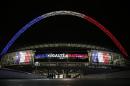 The front of London's Wembley Stadium is illuminated with the French flags flanking the words Liberte, Egalite, Fraternite