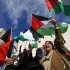 Palestinians wave flags during a rally in support of President Abbas' efforts to secure a diplomatic upgrade at the United Nations, in Ramallah