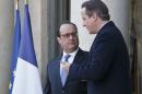 Britain's Prime Minister David Cameron, right, gestures as he speaks to France's President Francois Hollande after a meeting at the Elysee Palace in Paris, Monday, Nov. 23, 2015. Cameron and Hollande agree to increase counterterrorism cooperation after Paris attacks. (AP Photo/Michel Euler)
