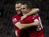 Manchester United's Robin van Persie, right, celebrates with teammate Ryan Giggs after scoring his third goal against Aston Villa during their English Premier League soccer match at Old Trafford Stadium, Manchester, England, Monday April 22, 2013. (AP Photo/Jon Super)