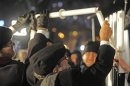 Poland's chief rabbi Michael Schudrich, center, lights the first candle celebrating the beginning of Hanukkah, the Jewish festival of lights, on Grzybowski square in Warsaw, Poland, Saturday, Dec. 8, 2012. (AP Photo/Alik Keplicz)