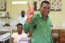 Andrew Holness, leader of the opposition Jamaican Labour Party, shows his ink-stained finger after casting his vote at a polling station during general election in Kingston, Jamaica