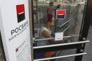 Woman walks out of an office of Rosbank in central Moscow
