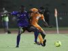 Kader of Ivory Coast fights for the ball with Samata of Tanzania during their world cup qualifier match in Abidjan
