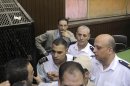 Islam Afifi, the chief editor of el-Dustour newspaper, center, attends a court hearing in Cairo, Egypt, Thursday, Aug. 23, 2012. A Cairo court on Thursday ordered the chief editor of an Egyptian newspaper detained pending trial on charges of insulting the country's president and 