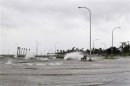 Water floods an area outside the levee system along the shore of Lake Pontchartrain as tropical storm Isaac approaches New Orleans