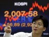 A currency trader reacts near a screen showing the Korea Composite Stock Price Index (KOSPI) at the foreign exchange dealing room of the Korea Exchange Bank headquarters in Seoul, South Korea, Friday, Sept. 14, 2012. Asian stock markets bound higher Friday after investors got just what they wanted - big moves by the Federal Reserve to help the U.S. economy out of its funk. (AP Photo/Lee Jin-man)