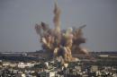 Smoke rises in Gaza City after an Israeli airstrike Saturday, Aug. 9, 2014. (AP Photo/Dusan Vranic)