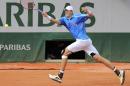 John Isner of the U.S. returns the ball during the first round match of the French Open tennis tournament against France's Pierre-Hugues Herbert at the Roland Garros stadium, in Paris, France, Sunday, May 25, 2014. (AP Photo/David Vincent)