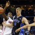 Duke's Mason Plumlee (5) is fouled as he drives between Davidson's De'Mon Brooks, left, and JP Kuhlman, right, during the first half of an NCAA college basketball game in Charlotte, N.C., Wednesday, Jan. 2, 2013. (AP Photo/Chuck Burton)