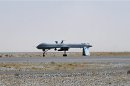 A U.S. Predator unmanned drone armed with a missile stands on the tarmac of Kandahar military airport