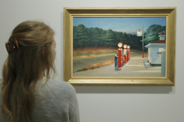 A woman looks at "Gas 1940" as part of the retrospective of Edward Hopper, one of the great American 20th century artists at Paris’ Grand Palais Museum, in Paris, Monday, Oct. 8, 2012. This major Hopper retrospective reveals that the 20th century painter known for his rendering of American life, also drew inspiration from France. (AP Photo/Francois Mori)