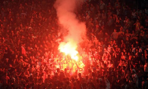 Fans of Tunisia's Esperance Sportive de Tunis light flares during their African Champions League soccer match against Tunisia's Etoile Sportive du Sahel at the Rades stadium in Tunis