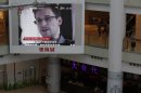 A TV screen shows the news of Edward Snowden, a former CIA employee who leaked top-secret documents about sweeping U.S. surveillance programs, at a shopping mall in Hong Kong Friday, June 21, 2013. President Barack Obama is holding his first meeting with a privacy and civil liberties board Friday as he seeks to make good on his pledge to have a public discussion about secretive government surveillance programs. (AP Photo/Kin Cheung)