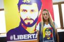 Lilian Tintori, wife of jailed Venezuelan opposition leader Leopoldo Lopez, poses for a picture in front of a poster depicting her husband at the office of the party Popular Will in Caracas