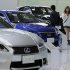A couple walk by Lexus models displayed at a Toyota Motor Corp. showroom in Tokyo Monday, Nov. 5, 2012. Toyota's quarterly profit tripled, driven by a recovery from natural disasters, and the company raised its full-year earnings forecast despite a sales slump in China. (AP Photo/Koji Sasahara)