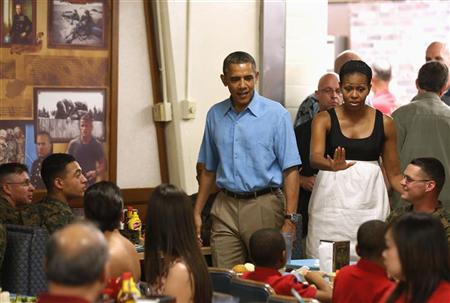 U.S. President Barack Obama and first lady Michelle Obama visit military personnel and their families as they walk into Anderson Hall base chow hall at the Marine Corps Base Hawaii in Kaneohe Bay, Hawaii December 25, 2012. REUTERS/Larry Downing