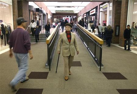 An elderly man walks with his cane amid shoppers at the Glendale Galleria shopping mall on Black Friday in Glendale, California November 28, 2008. REUTERS/Fred Prouser