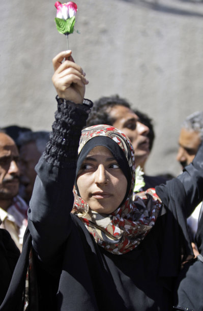 FILE - In this Jan. 26, 2011 file photo, Yemeni activist Tawakul Karman, who was jailed for leading protests at the weekend, holds a rose during an anti-government protest in Sanaa, Yemen. Liberian President Ellen Johnson Sirleaf, Liberian activist Leymah Gbowee and Tawakkul Karman of Yemen have won the 2011 Nobel Peace Prize, the Norwegian Nobel Committee announced Friday, Oct. 7, 2011. (AP Photo/Hani Mohammed, File)