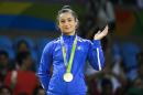 Kosovo's Majlinda Kelmendi receives the gold medal after winning the women's 52-kg judo competition at the 2016 Summer Olympics in Rio de Janeiro, Brazil, Sunday, Aug. 7, 2016. (AP Photo/Markus Schreiber)