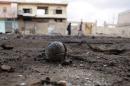 An unexploded cluster bomblet is seen along a street after airstrikes by pro-Syrian government forces in the rebel held al-Ghariyah al-Gharbiyah town, in Deraa province
