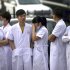 Medical staff wait near a poultry processing plant that was engulfed by a fire in northeast China's Jilin province's Mishazi township on Monday, June 3, 2013. The massive fire broke out at the poultry plant early Monday, trapping workers inside a cluttered slaughterhouse and killing over a hundred people, reports and officials said. (AP Photo) CHINA OUT