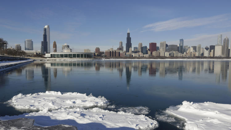 Ice floats on the surface of Lake Michigan Friday, Jan. 3, 2014, in Chicago. Single-digit temperatures are hitting Illinois after the state was blanketed in snow. Meanwhile, residents are bracing for a deep freeze. Highs early next week likely won't reach zero and wind chills could sink to 45 below. (AP Photo/M. Spencer Green)