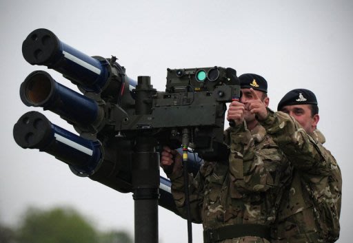 A Starstreak high velocity missile system, which could play a role in providing air security during the Olympics, is manned by members of the British Royal Artillery during a media demo in southeast London in May 2012. British residents living near London's Olympic Park launched legal action Thursday over government plans to station surface-to-air missiles on the roof of their rented flats. (AFP Photo/Carl Court)